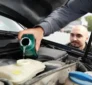 Mechanic fixing a car brake fluid leak in the brake system